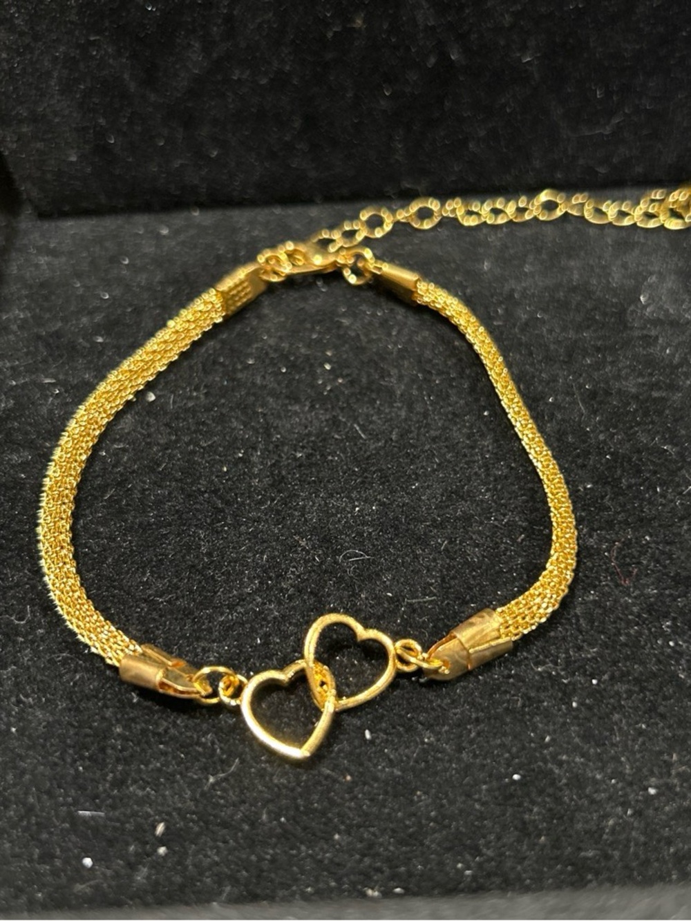 Gold color bracelet with interlocking hearts